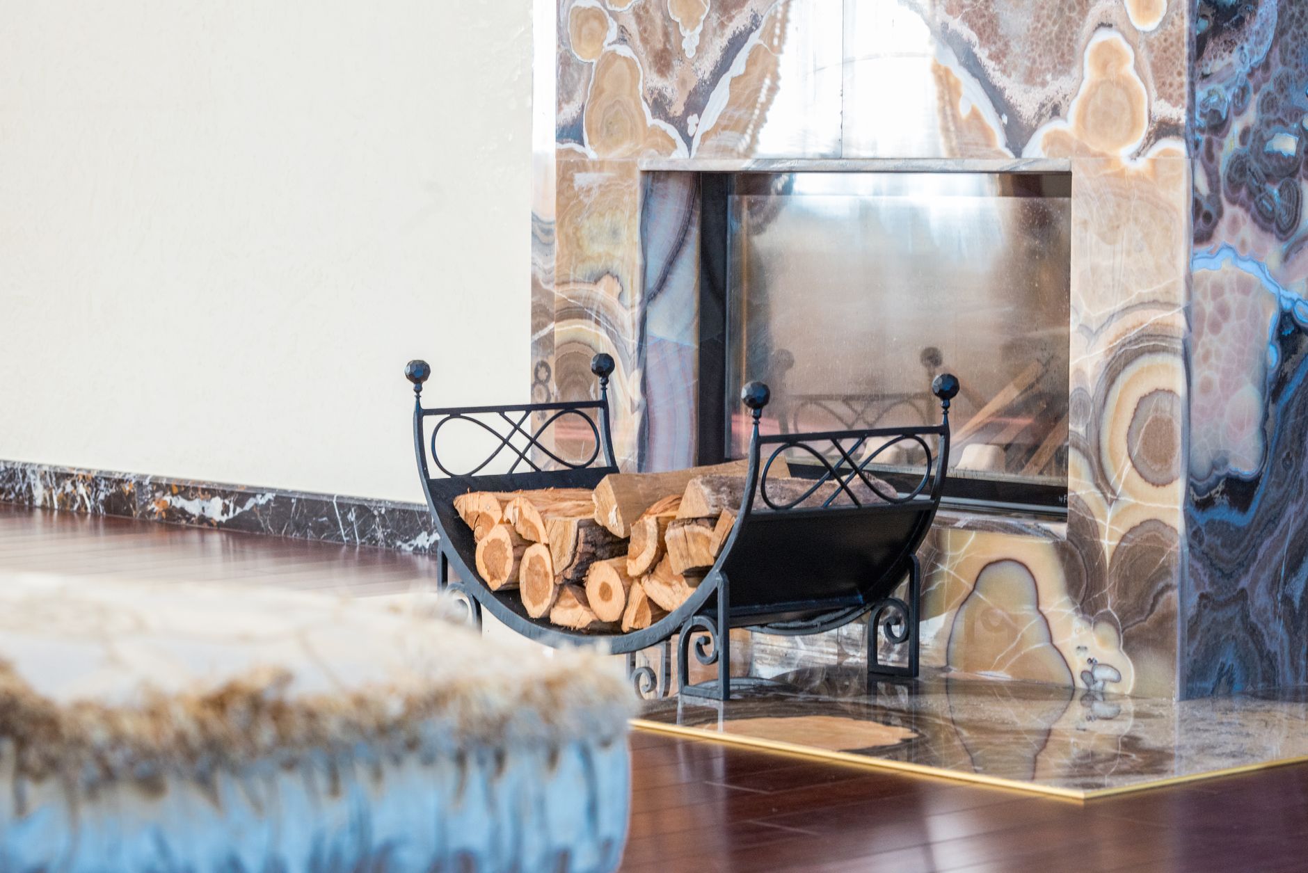 An elegant living room with a marble fireplace