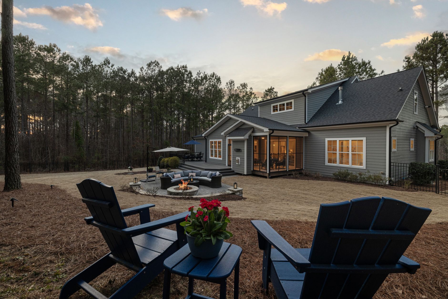A warm backyard evening with a fire pit and seating